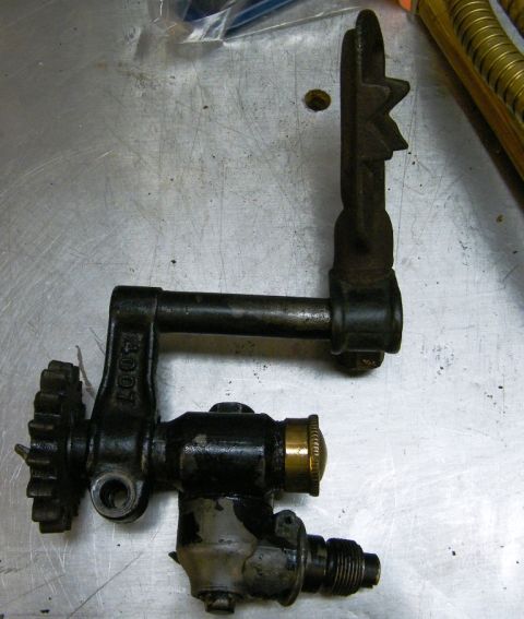 1909 Ford Model T - This mechanical component features a gear on the left and a distinctive star-shaped lever on the right.