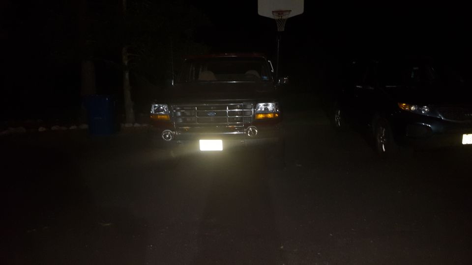 1992 Ford Bronco front view at night with headlights on