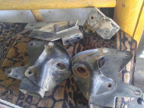 1991 Ford Bronco - Collection of used suspension brackets, possibly for an older truck or SUV.