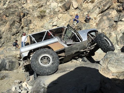 1961 International Scout 800 - This heavily modified vehicle is attempting to traverse a challenging rocky obstacle course.