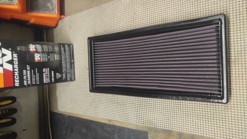 1991 Ford Bronco - A K&N air filter and its accompanying cleaning kit are displayed on a textured surface.