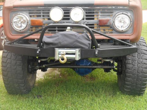 1972 Ford Bronco - The front of a modified Ford Bronco shows off its custom bumper, winch, and suspension components.
