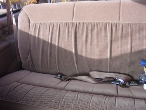 1992 Ford Bronco - Interior view of a vehicle's bench seat with seatbelts.