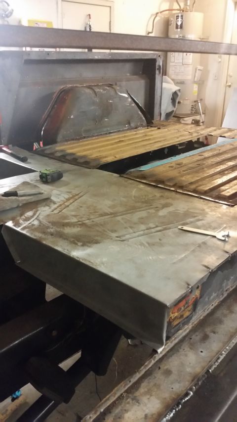 1979 Ford Bronco - The bed of a truck is undergoing repair work, with visible metal sheeting and structural components.