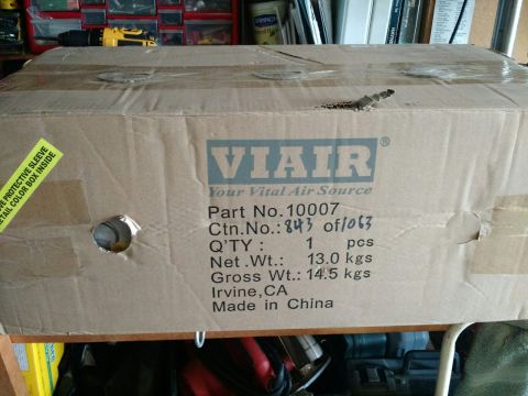 1992 Ford Bronco - A cardboard box for an onboard air system is shown with shipping and product information printed on its side.