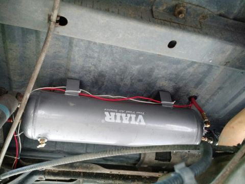 1992 Ford Bronco - VIAIR air tank installed under the vehicle chassis, connected with red and white wires.