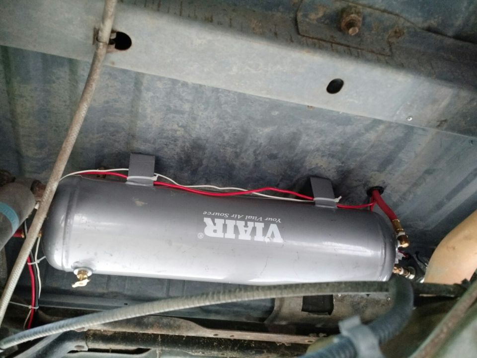 VIAIR air tank with red and white wires mounted under a vehicle chassis