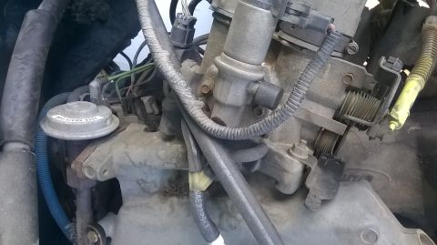 1996 Ford F-150 - Engine components, specifically the throttle body and EGR valve, are shown in this close-up view.