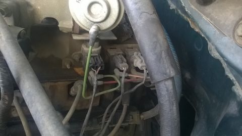 1996 Ford F-150 - This image shows various electrical connectors and wiring within a vehicle's engine compartment.