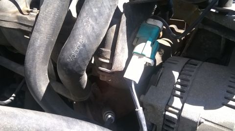 1996 Ford F-150 - This image shows a close-up view of various engine components, including hoses and an electrical connector.
