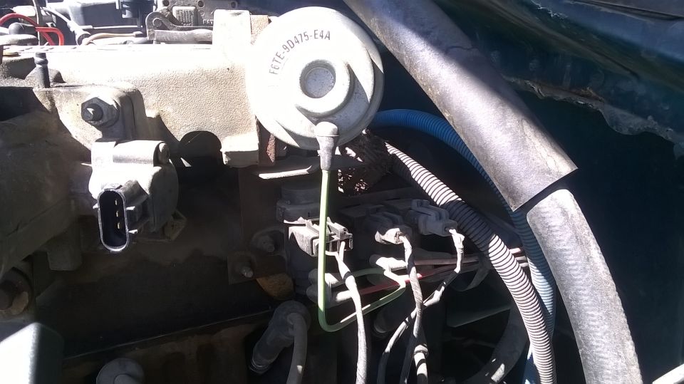 Close-up of engine component with part number F6TE-90475-E4A visible