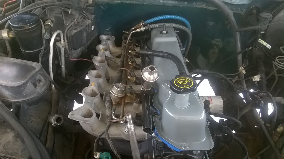 Close-up of a 1996 Ford F-150 engine bay, showing the intake manifold and valve cover