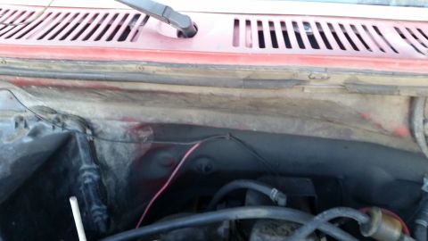 1981 Ford Bronco - This image shows the engine bay of a red vehicle, likely a 1981 Ford Bronco, with various hoses, wires, and engine components visible. The…