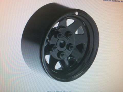 1989 Ford Bronco - A black aftermarket wheel with a triangular spoke design is shown at an angle against a light background. The wheel has a polished lip and…