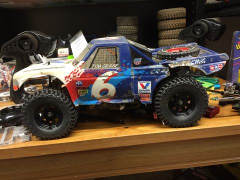 1989 Ford Bronco - A modified remote-controlled off-road truck with a blue and red paint scheme and the number 6 is displayed on the side. The truck is sittin…