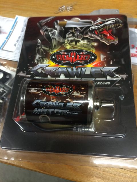 1989 Ford Bronco - A packaged RC4WD Crawler motor is displayed in its blister pack. The packaging features a graphic of a dinosaur-like creature and the text…