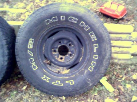 1986 Ford Bronco - Close-up of a Michelin LTX tire and steel wheel, with another tire partially visible.