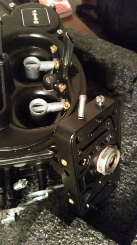 1981 Ford Bronco - A close-up, angled view of a black aftermarket carburetor, likely for a classic vehicle. The carburetor features various brass fittings and…