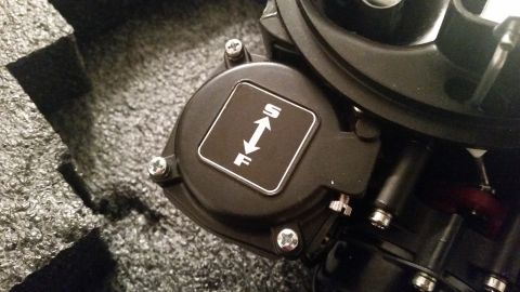 1981 Ford Bronco - A close-up view shows a black component with a square emblem featuring white text and arrows indicating 'S' and 'F'. The part is mounted on…