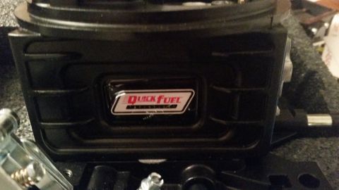 1981 Ford Bronco - A black Quick Fuel carburetor is shown from a low angle, with a close-up of the brand logo on the side.