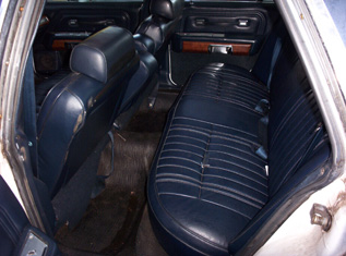 1991 Ford Crown Victoria LTD - Interior view of a sedan's rear seating area, blue vinyl upholstery and wood trim accents. A watermark for Supermotors is visible.