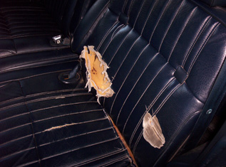 1991 Ford Crown Victoria LTD - Interior shot of a car seat showing significant damage to the upholstery.