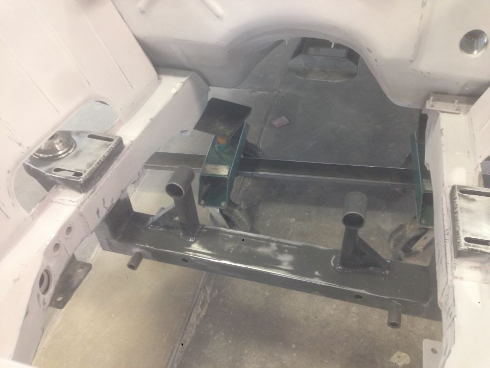 Underside of a vehicle chassis with metal frame components and brackets.
