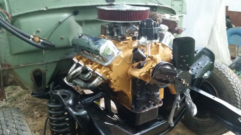 Gold engine with chrome valve covers and headers in engine bay