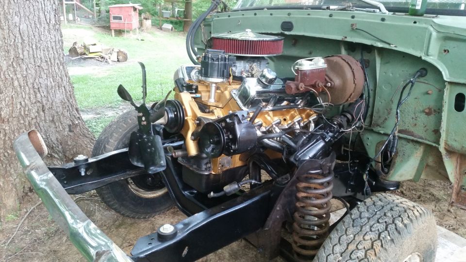 Engine bay with gold-painted V8 engine and red air filter