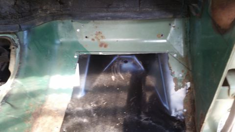 Interior floor panel with cut-out and rust spots