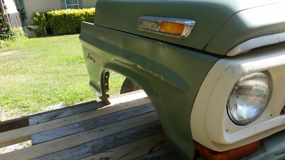 Green fender and headlight assembly of a 1973 Ford F-Series truck