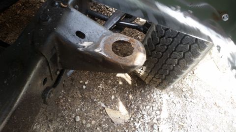 Close-up of vehicle frame with tow hitch and tire
