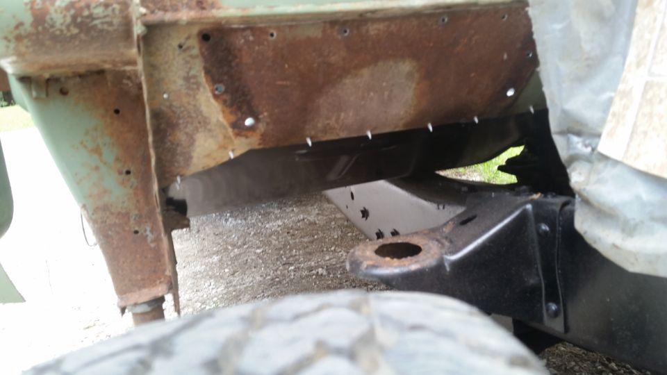 Rusted vehicle frame and tire with Supermotors.net watermark