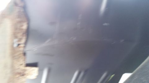Close-up of gray interior paneling with a textured brown edge visible on the left