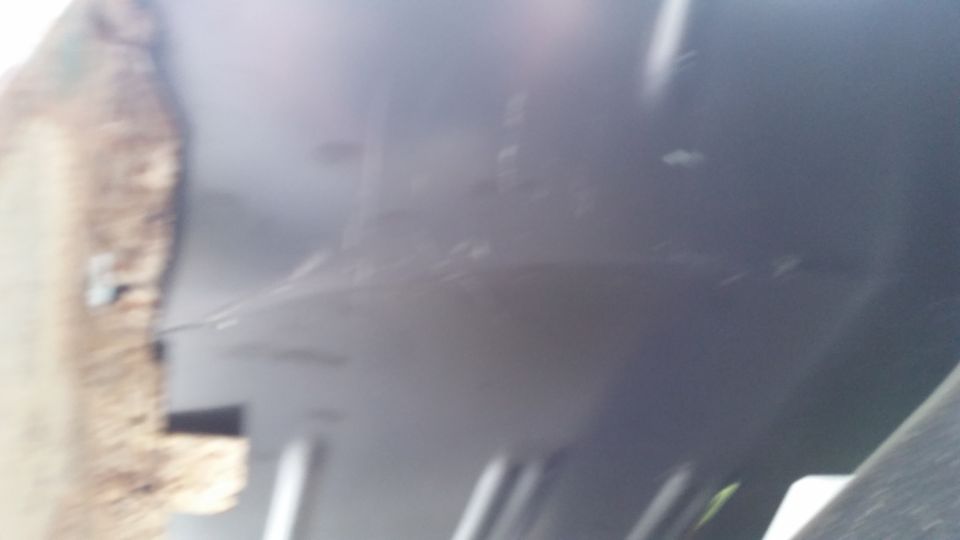 Close-up of gray interior paneling with a textured brown edge visible on the left