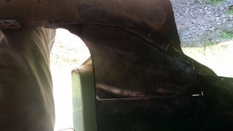 Interior body panel with visible rust and repair work