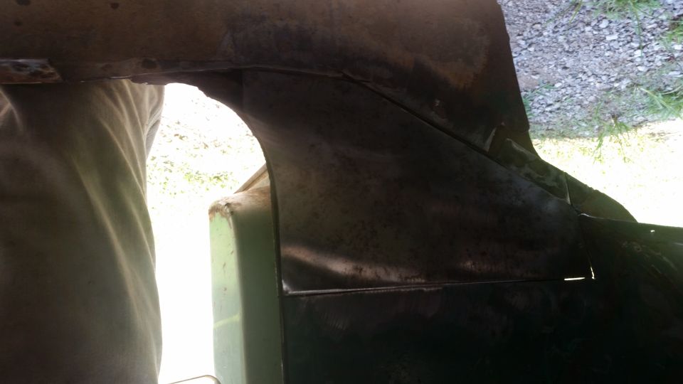 Interior body panel with visible rust and repair work