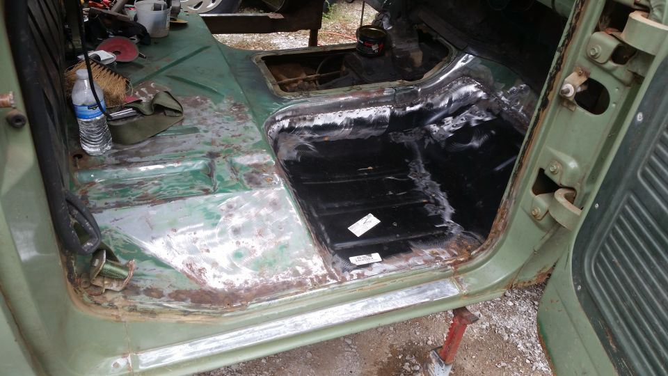 Green 1978 Ford Bronco interior with rust damage and repair work