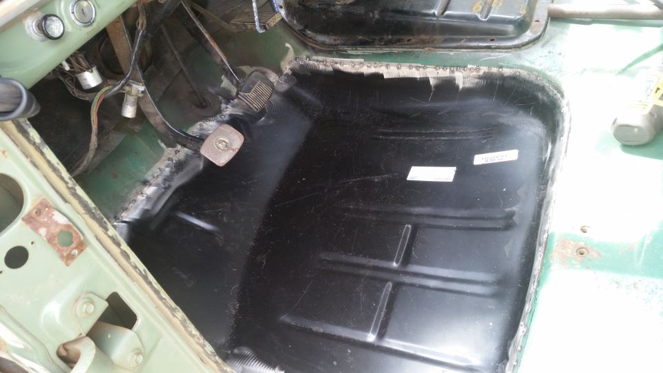 Interior floor pan with black coating and some white labels
