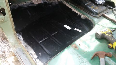 1978 Ford Bronco interior floor pan with black coating and some rust