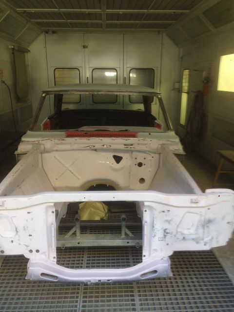 1964 Ford Fairlane - Body shell of a 1964 Ford Fairlane undergoing preparation in a paint booth.