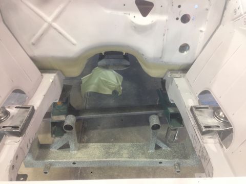 1964 Ford Fairlane - Underside view of a car's chassis, prepared for restoration or repair.