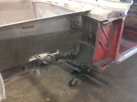 1964 Ford Fairlane - Unidentified car body section on jack stands, likely undergoing restoration work.