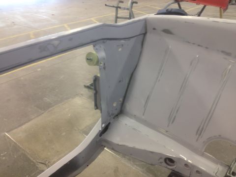 1964 Ford Fairlane - The bare metal frame of a car is shown, undergoing preparation for a new paint job.