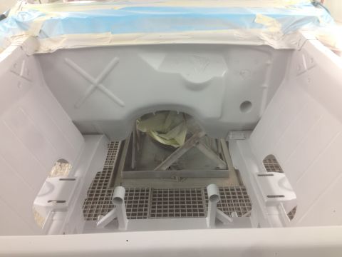 1964 Ford Fairlane - Engine bay being prepped for paint, showing the firewall and surrounding structure.