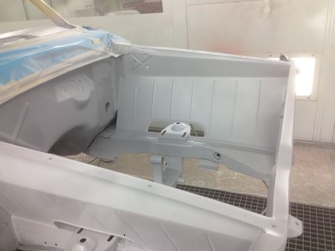 1964 Ford Fairlane - The interior of a car's chassis is shown, covered in primer and ready for further work.