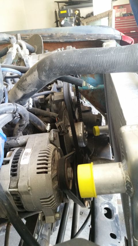 1979 Ford Bronco - Close-up view of the engine bay components, including the alternator and radiator system.