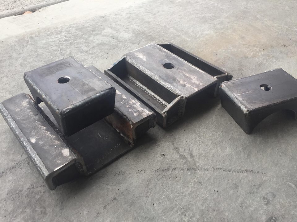 Fabricated steel suspension parts on concrete floor