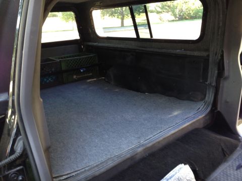 2001 Ford Ranger - Pickup truck bed interior, showing carpeted floor and two milk crates.