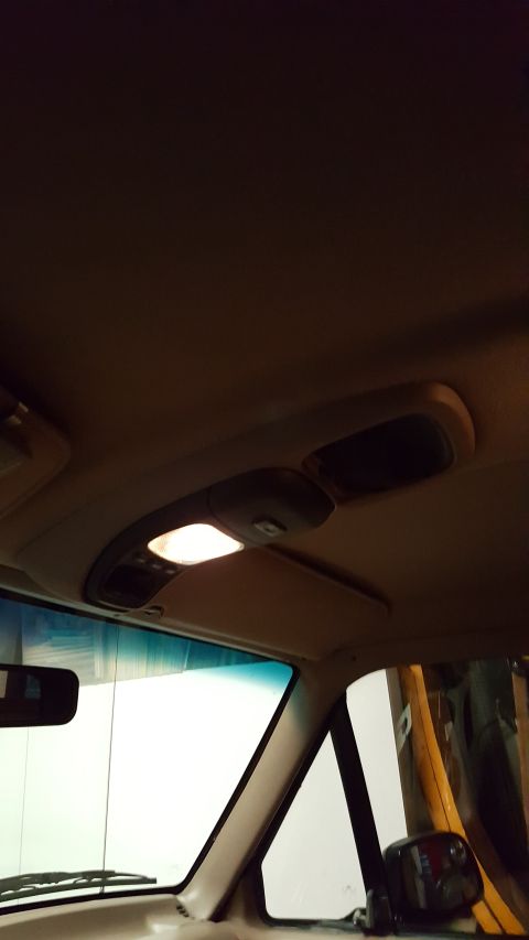 1996 Ford Bronco - The interior overhead console features an illuminated light and two storage compartments.
